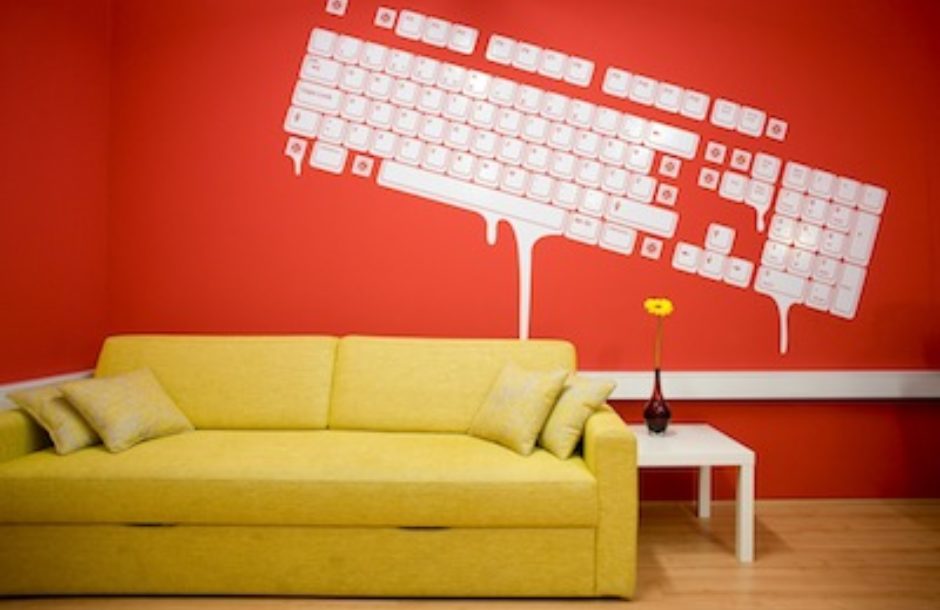 Red color wall with keyboard painting and yellow sofa with white table